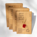 Wrapped surprise books in brown paper tied with string and a red wax seal.
